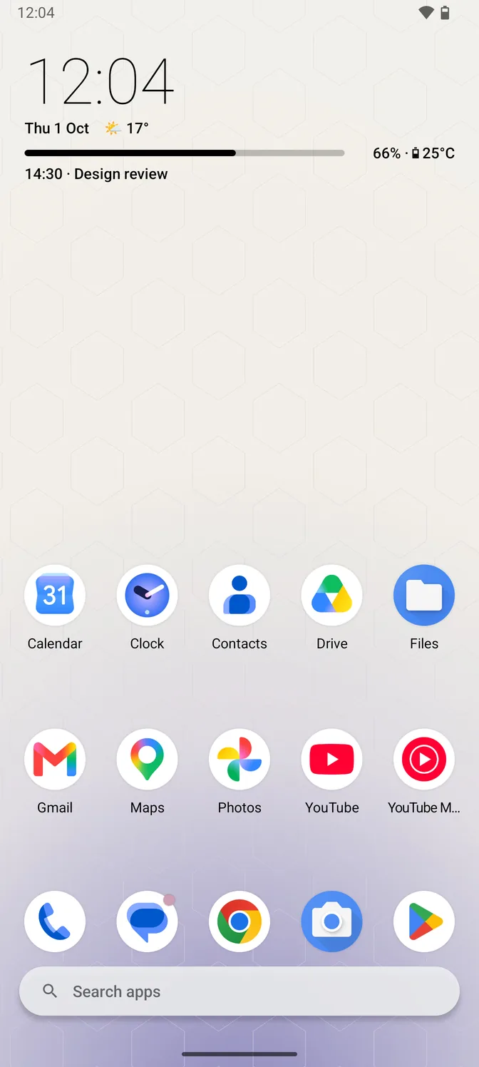 The home screen in the light theme: a large clock in dark type, the date with the current temperature beside it, and the next calendar event, above two rows of app icons, a dock and a search bar, over a pale honeycomb wallpaper.